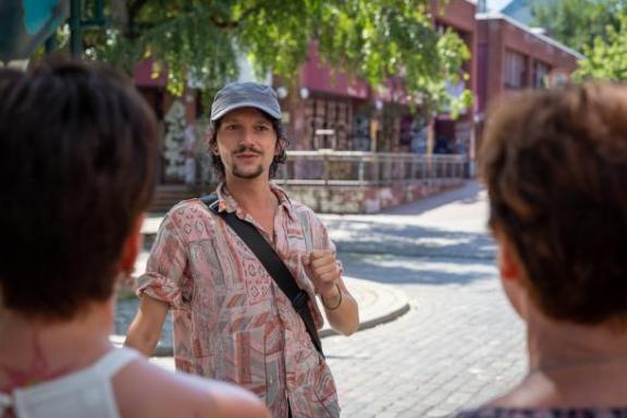 Ein Tourguide mit grauer Kappe