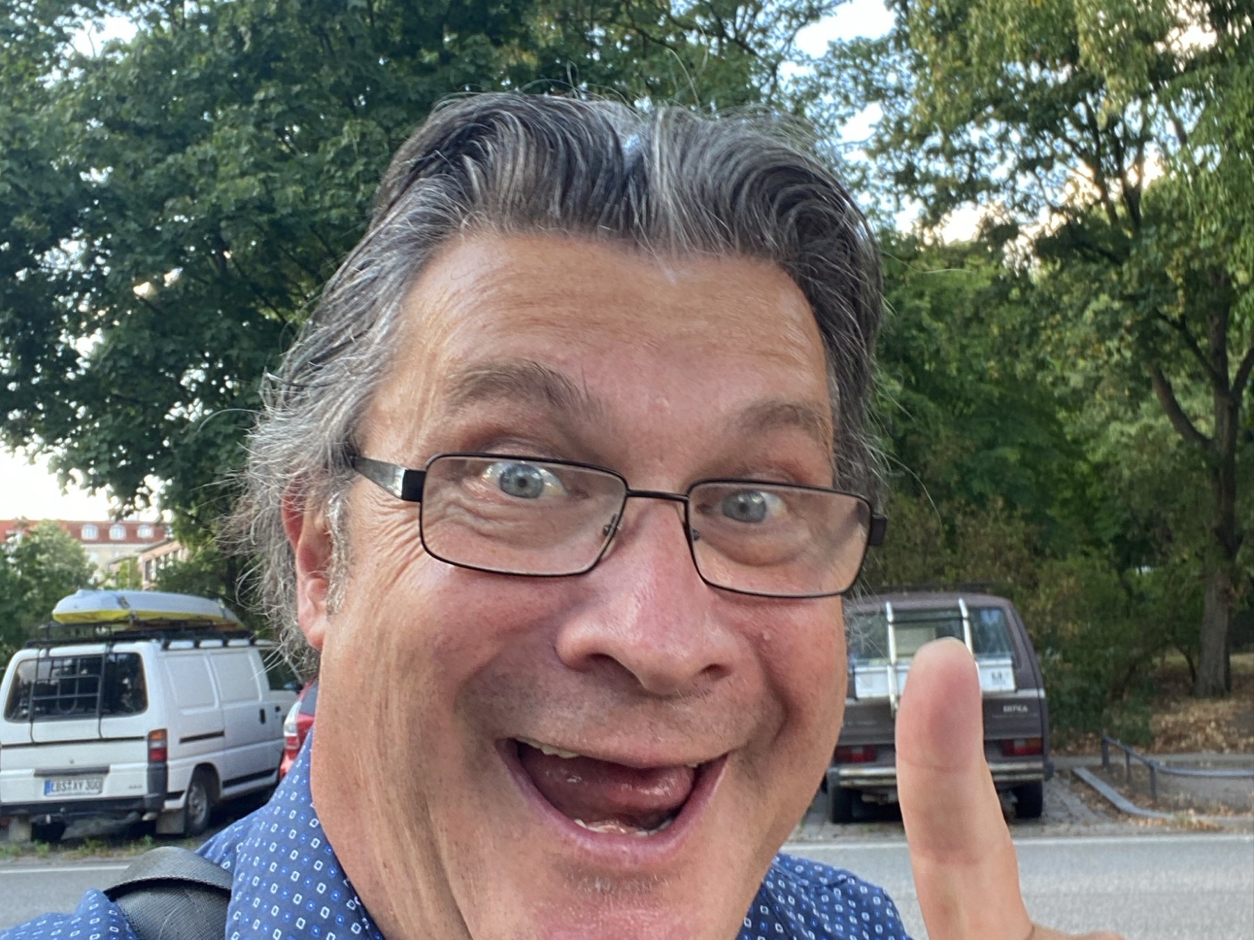 a man wearing glasses talking on a cell phone