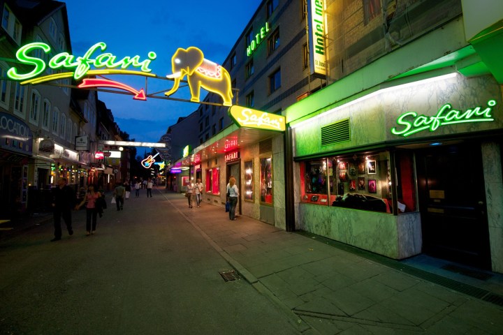 a group of people walking in front of a store