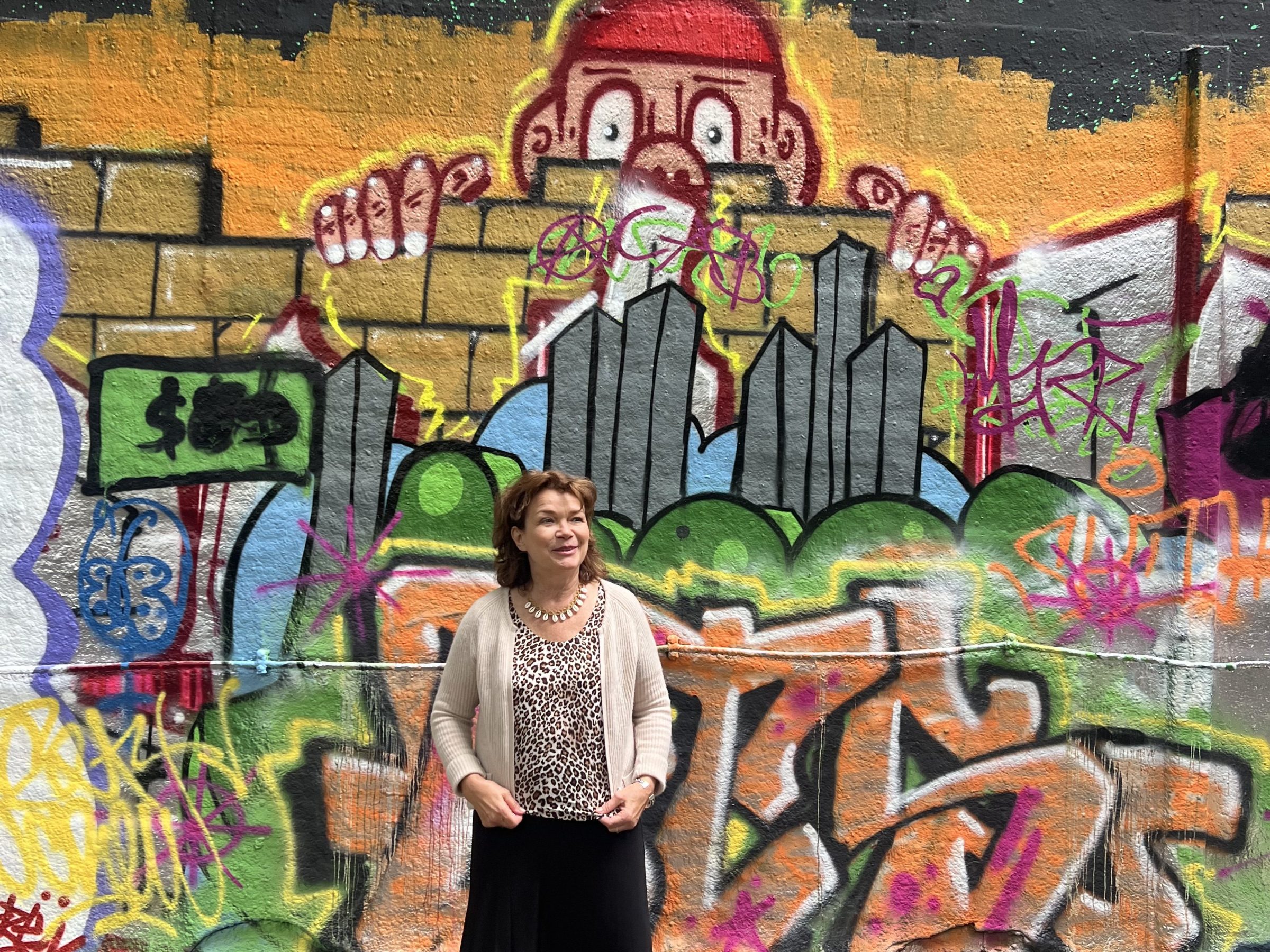 a person with graffiti on the side of a building