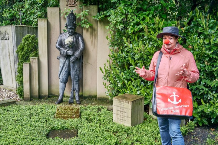 a little girl standing in front of a statue