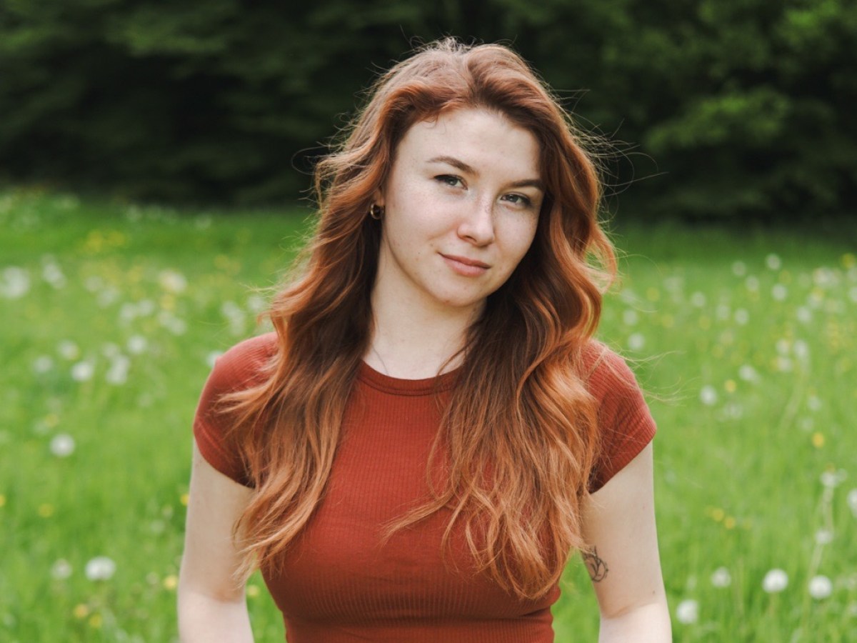 a woman standing in the grass