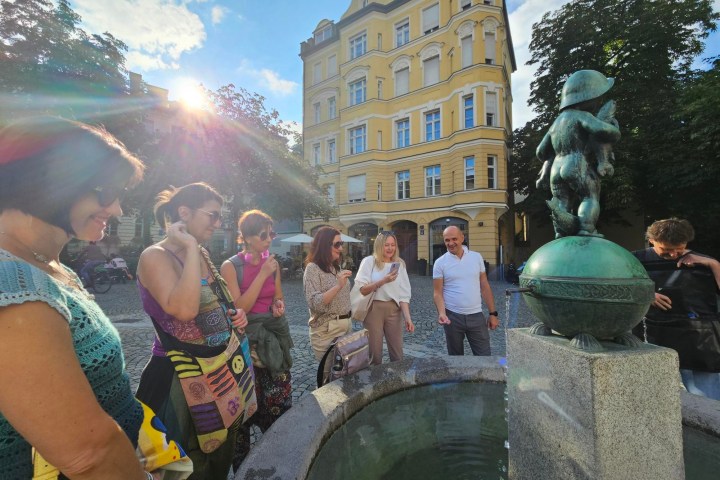 a group of people standing in front of a statue