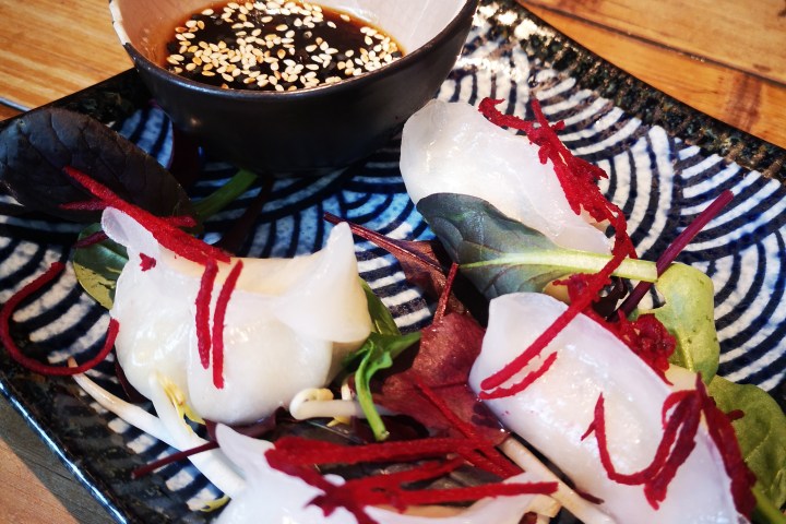 a plate of food sitting on top of a wooden table