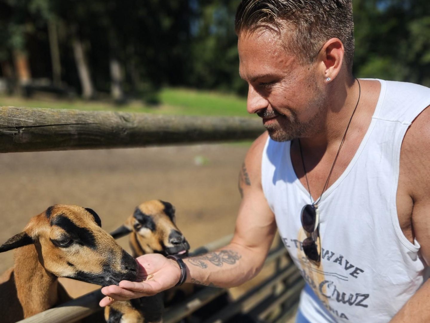 a man standing next to a fence