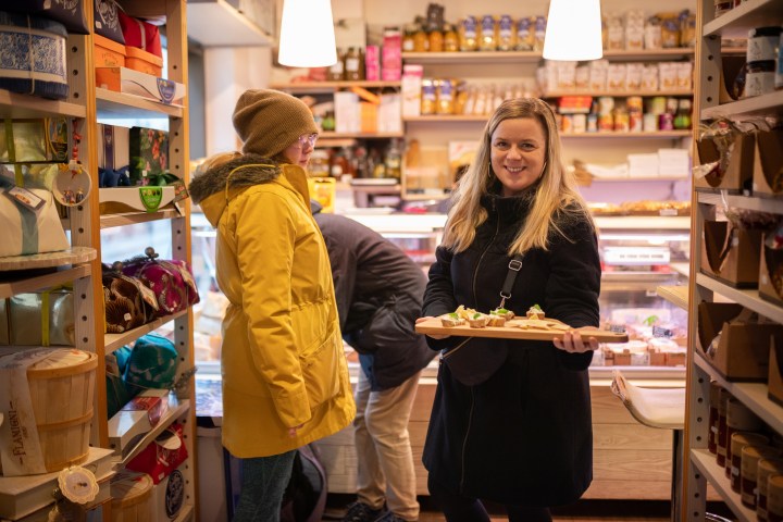 a woman standing in front of a store