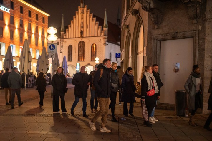 a group of people walking in front of a building