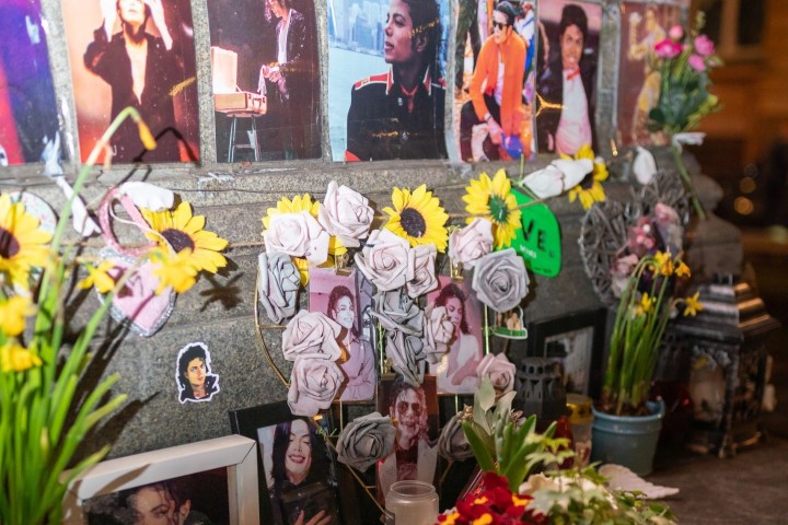 Michael Jackson, Michael Jackson sitting at a table with a vase of colorful flowers