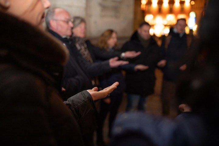 a group of people looking at a cell phone