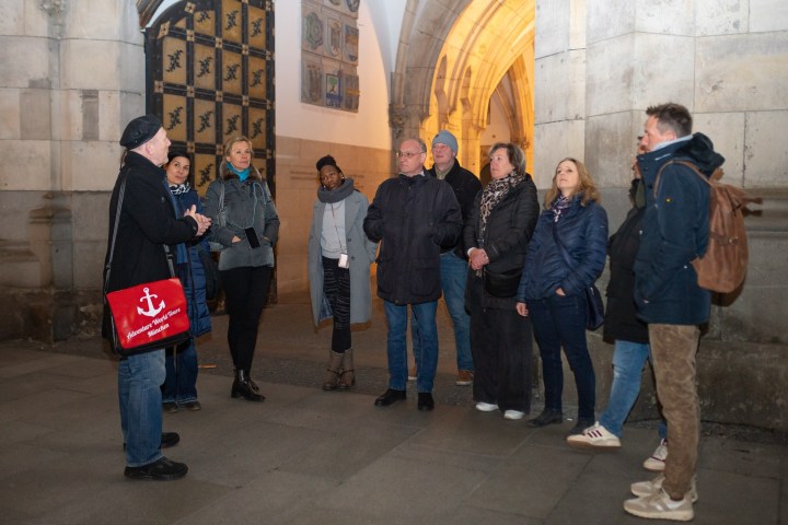 a group of people standing in front of a building