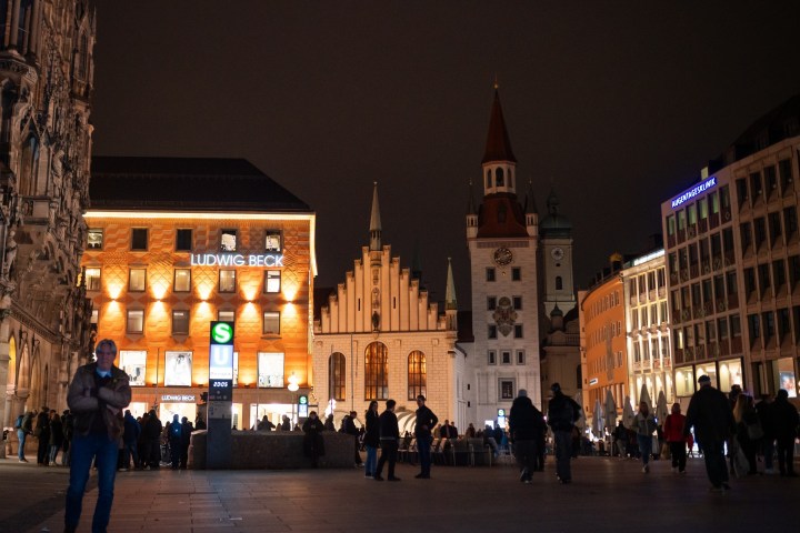 a group of people walking in front of a building