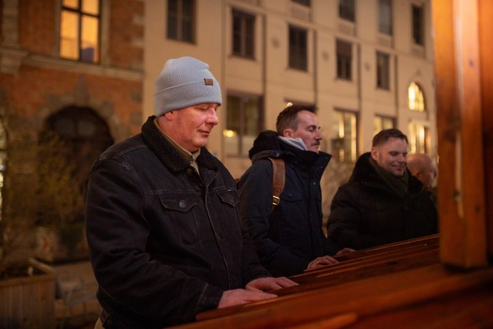a man and a woman sitting at a table in front of a building