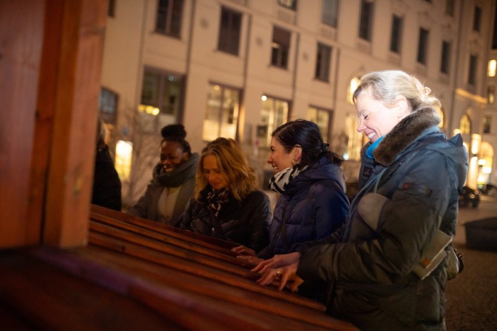 a man and a woman sitting in front of a building